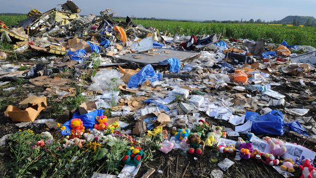 Flowers and plush toys are left at the MH17 crash site in Grabove, eastern Ukraine, in 2014.