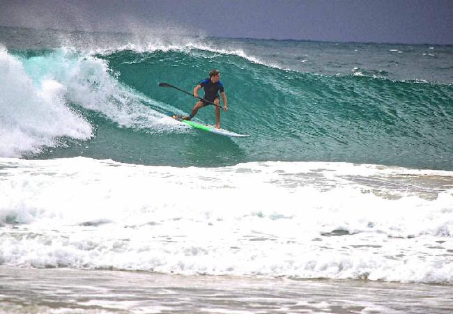 WHAT’S SUP?: Trevor Tunnington catches a wave on his stand up paddleboard. Picture: Di Tunnington