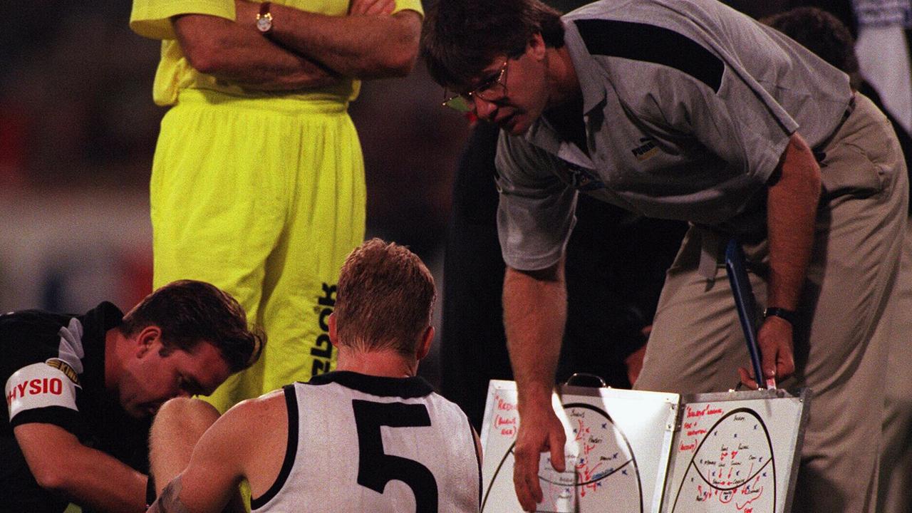 Danny Frawley, as a Collingwood assistant, talks to Nathan Buckley during a 1997 AFL match.