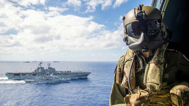 Petty Officer Aircrewman Leeann Mumby watches a replenishment at sea between HMAS Ballarat (front) and USS America off the coast of Queensland, during Exercise Talisman Sabre 2021. Picture: Supplied