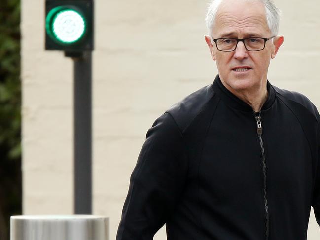 Former prime minister Malcolm Turnbull with his wife Lucy and daughter Daisy leaving The Lodge in Canberra for a walk. Picture Jonathan Ng