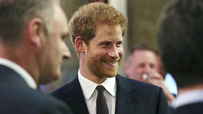 Prince Harry mingles with recipients of the Queen's Young Leaders Awards at Australia House in central London. Picture: AP