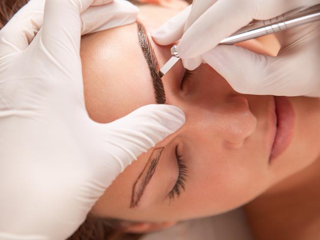 A young woman is receiving eyebrow treatment. Picture: iStock.