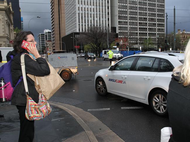An officer directing evening traffic around the city. Picture: Emma Brasier
