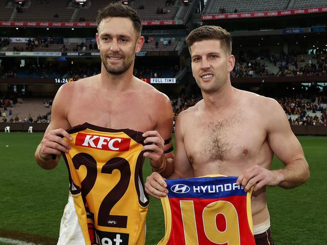 Jack Gunston of the Lions and Luke Breust of the Hawks swap jumpers after their round 13 clash. Picture: Michael Klein