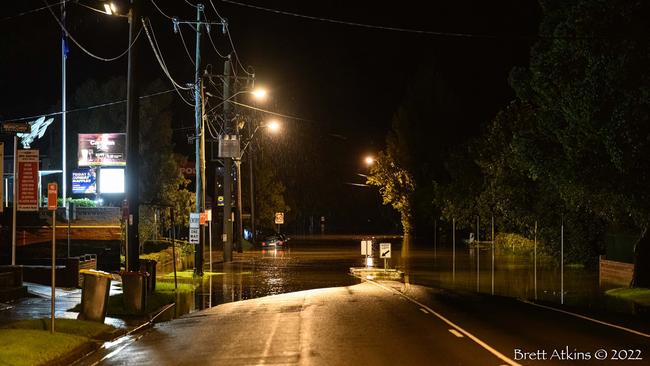 Cawdor Rd with floodwaters encroaching on the Camden RSL and the Camden Sports Club in the early hours of March 8, 2022. Picture: Brett Atkins