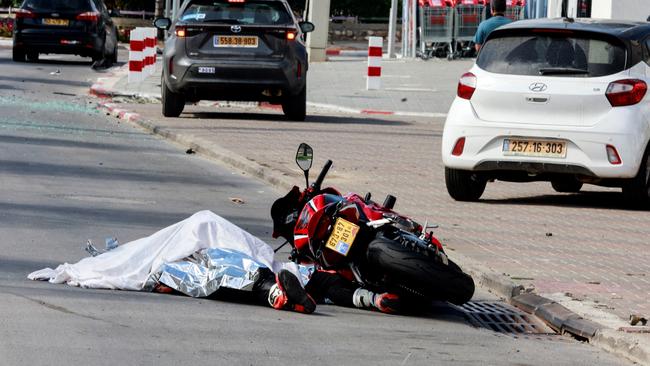 The body of a motorist lies on a road following a mass-infiltration by Hamas gunmen from the Gaza Strip, in Sderot, southern Israel. Picture: Ammar Awad / Reuters