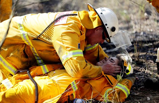 Peter Kelly’s award-winning photo of a firefighter helping another who was hit by a falling tree branch at Londonderry in November.