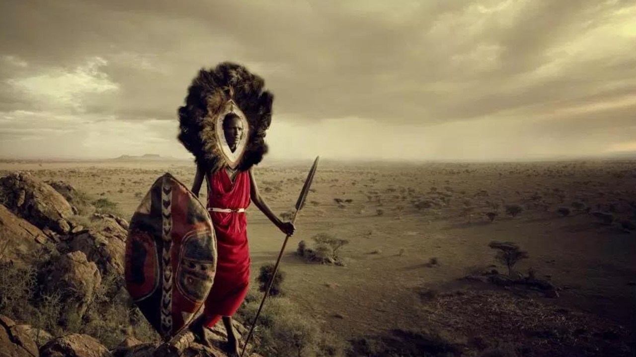 A member of the Maasai tribe in Tanzania stands looking over the plains. Picture: Jimmy Nelson
