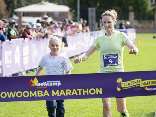 Kathryn Parkinson, running with her daughter Madison Jones, is the first female to finish the Toowoomba Marathon, Sunday, May 5, 2024. Picture: Kevin Farmer