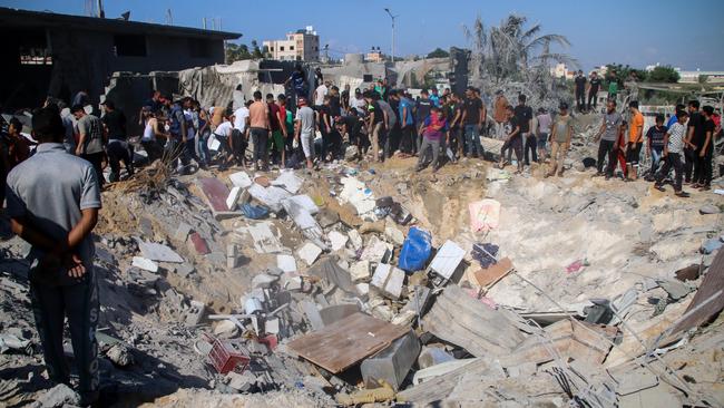 Palestinian emergency services and local citizens search for victims in buildings destroyed during Israeli air raids in the southern Gaza Strip on October 19. Picture: Getty