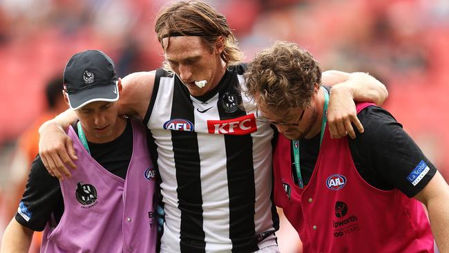 Nathan Murphy is helped from the ground during the Pies’ clash with GWS. Picture: Getty Images