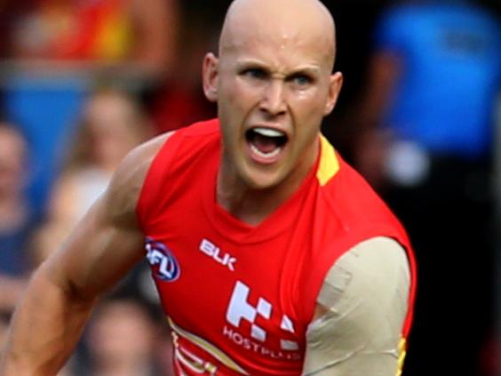 Gary Ablett of the Gold Coast Suns hand passes against Essendon Bombers during their round 1 AFL match at the Metricon stadium, Gold Coast. Photo: Regi Varghese