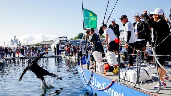 Christian Beck is thrown into the water by his crew during an official presentation for the annual Sydney to Hobart yacht race.