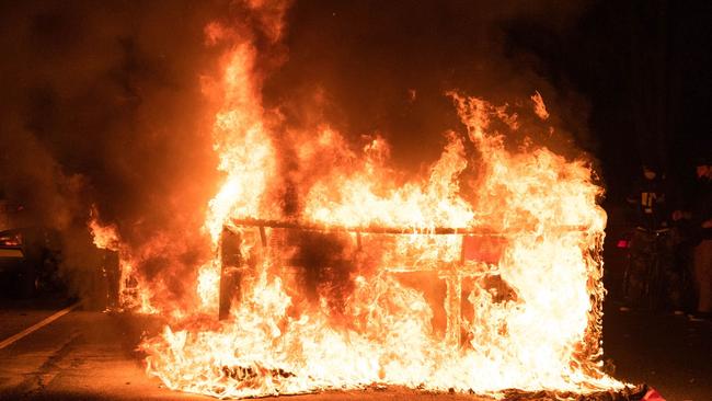 A sofa set on fire by protesters burns in a street in West Philadelphia. Picture: AFP