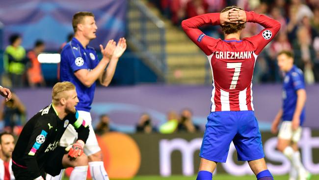 Atletico Madrid's French forward Antoine Griezmann (R) gestures after missing a goal.