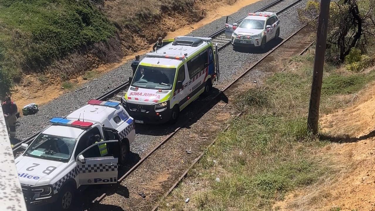 Police and paramedics parked on the tracks where a man lay in front of a freight train. Picture: Eddie Russell