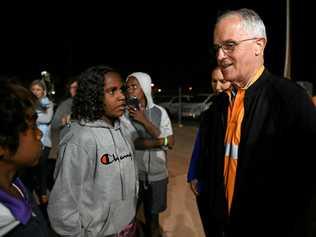 SEEKING ANSWERS: Prime Minister Malcolm Turnbull meets local kids as he rides along in a Julalikari Youth Night Patrol convoy at Tennant Creek . Picture: DAN HIMBRECHTS