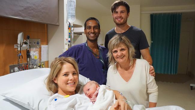 Obstetrician and gynaecologist Shavi Fernando with his two patients and their family.