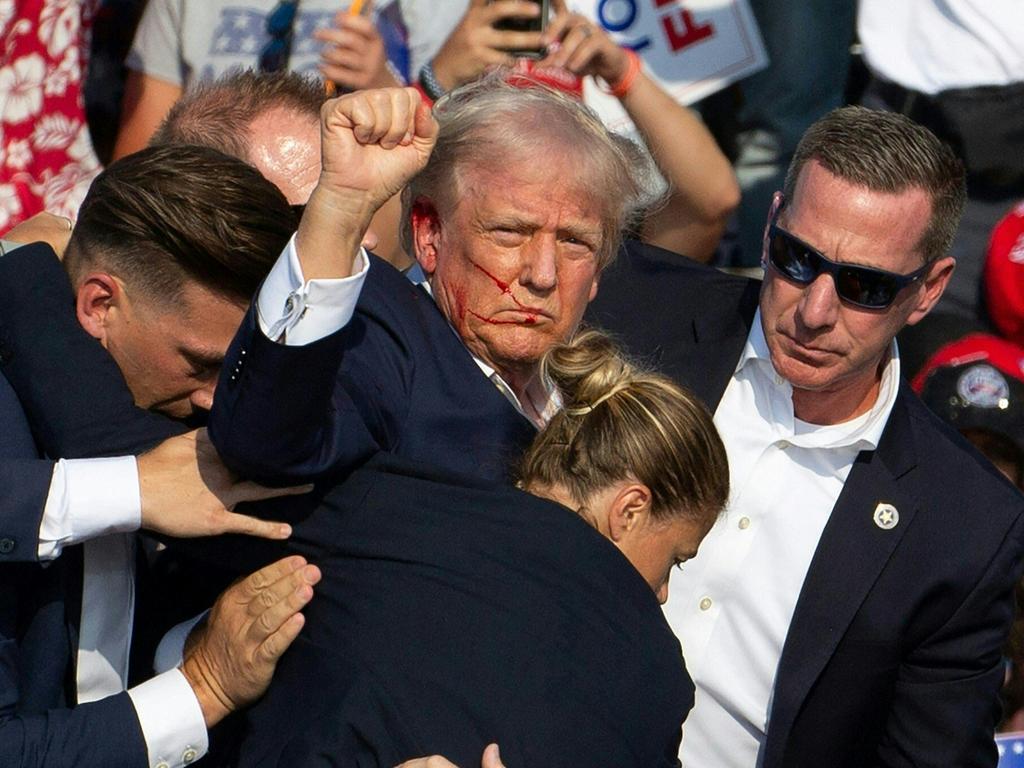 Donald Trump is seen with blood on his face surrounded by secret service agents as he is taken off the stage at a campaign event in Butler, Pennsylvania. Picture: Rebecca Droke / AFP