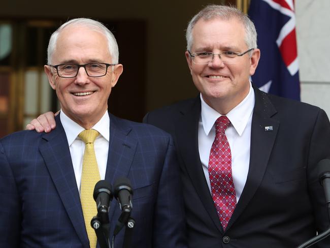 Mr Morrison embraces Mr Turnbull in response to a question about his own leadership ambitions. Picture: Kym Smith