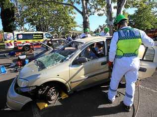 Tweed Volunteer Rescue Association president Drew Carr rescues patients in a mock emergency scenario for students at Murwillumbah. Picture: Scott Powick