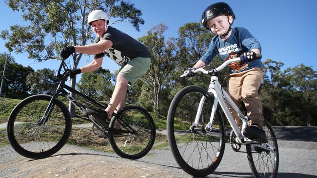 Hunter Clemett (5) and Dad Wayne, enjoy a beautiful winters day at Underwood Park. Qld is enjoying a fine and sunny weekend after a day of rain and fog. (AAP Image/Jono Searle)