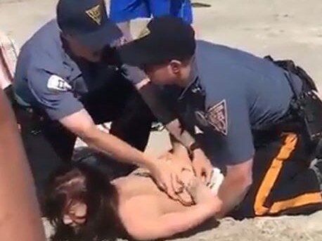 Punch 1 - Emily Weinman pinned by police Picture: Twitter