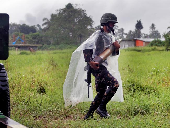 Soldiers from the 1st Field Artillery Battalion fire 105mm Howitzer shells into the township of Marawi in an attempt to kill the IS militants who are still in the town. Picture: Gary Ramage