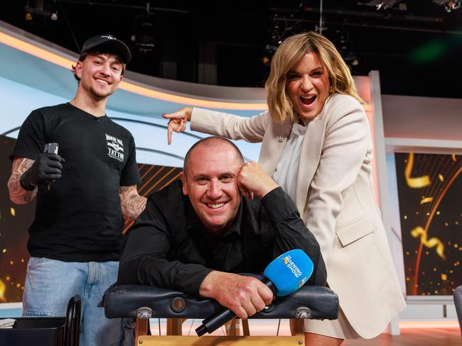 Tattooist Zach Spiros, tattoos Logies winner Larry Emdur live on air on The Morning Show, while cohost Kylie GIllies watched on laughing. Picture: Justin Lloyd.