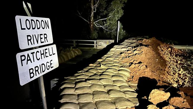 Darkness falls on the Patchell Bridge as floodwaters approach. Picture: Dennis Greenwood