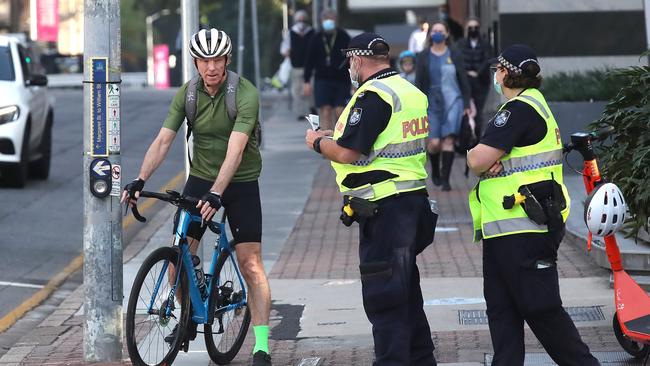 Police perform compliance checks in the Brisbane CBD. Picture: NCA NewsWire / Jono Searle