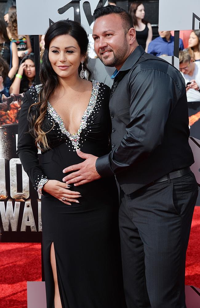 Jennifer 'JWoww' Farley and her fiance Roger Mathews attend the 2014 MTV Movie Awards at Nokia Theatre L.A.