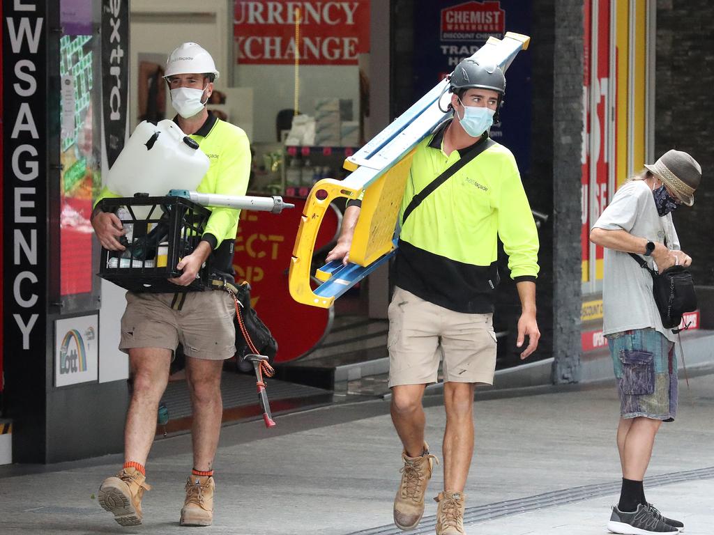 Tradesmen wearing their masks in Queens Street Mall. Picture: Liam Kidston.