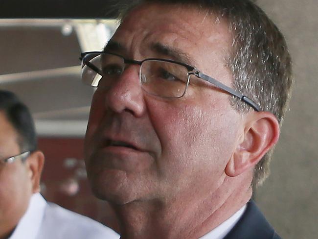 U.S. Defense Secretary Ash Carter gestures as he arrives for the closing ceremony of the 11-day joint US-Philippines military exercise dubbed "Balikatan 2016" (Shoulder-To-Shoulder 2016) Friday, April 15, 2016 at Camp Aguinaldo in suburban Quezon city, northeast of Manila, Philippines. Carter is visiting the aircraft carrier USS John C. Stennis sailing in the South China Sea on Friday. Second from left is Foreign Secretary Jose Almendras. (AP Photo/Bullit Marquez)