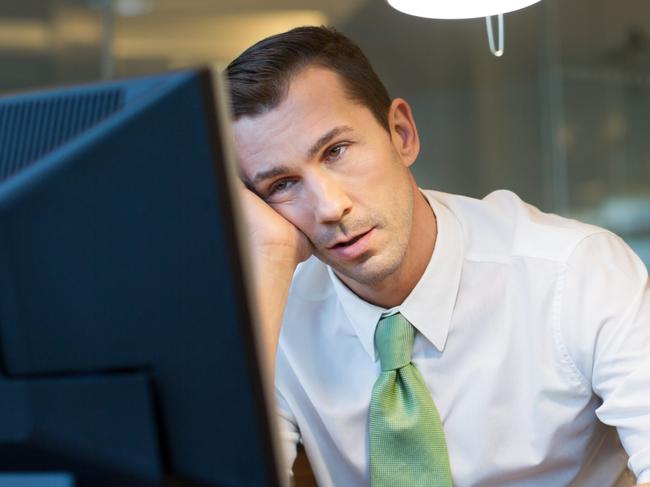 Exhausted businessman working overtime in the office