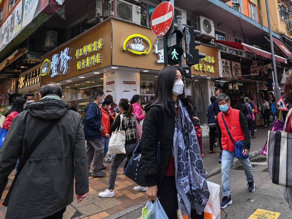 People walk along a street in the town of Sheung Shui in Hong Kong where the nearby border with mainland China was shut for three years until January 8. Picture: Peter Parks/AFP