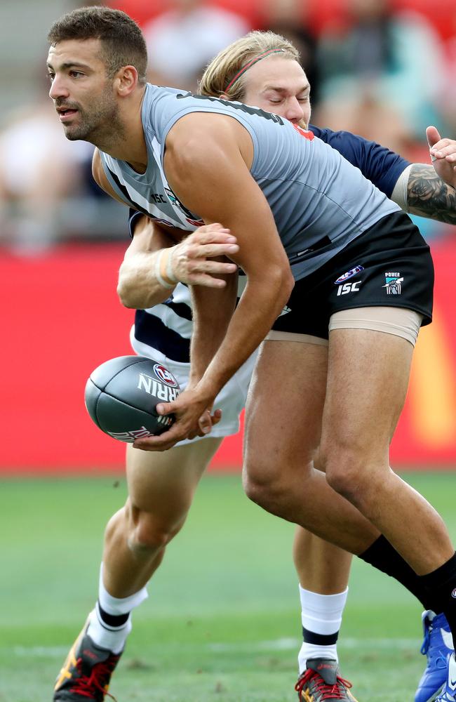 Port Adelaide’s Jimmy Toumpas is tackled by Geelong’s Tom Stewart during an AFLX game at Hindmarsh Stadium in February. Picture: Calum Robertson