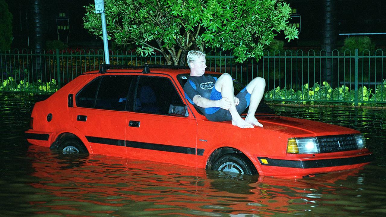 Man takes refuge on his car in Coffs Harbour during flash flood following heavy rain.    New South Wales (NSW) / Weather / Floods