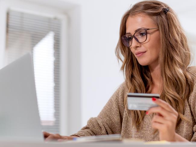 A young woman on her computer using a credit card to pay for goods. Picture: iStock.