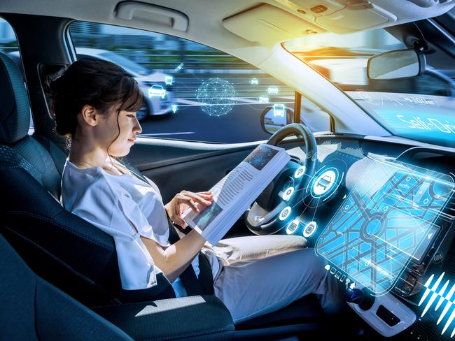 young woman reading a magazine in a autonomous car. driverless car. self-driving vehicle. heads up display. automotive technology.