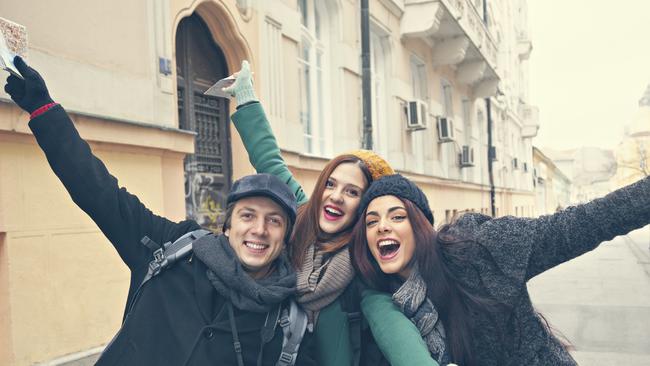 Happy Tourists Enjoying The City And Posing For Photo