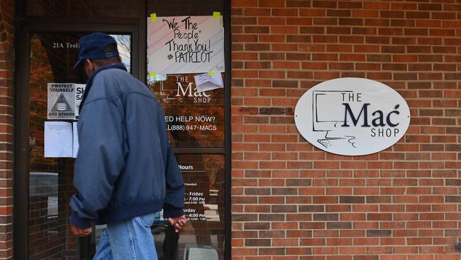 A man walks past "The Mac Shop" in Wilmington, Delaware where Hunter Biden left his now infamous laptop, which the Biden administration and others claimed was fake news and Russian misinformation. Picture: AFP