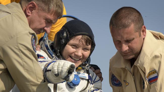 Astronaut Anne McClain is helped from the space craft. Picture: AFP