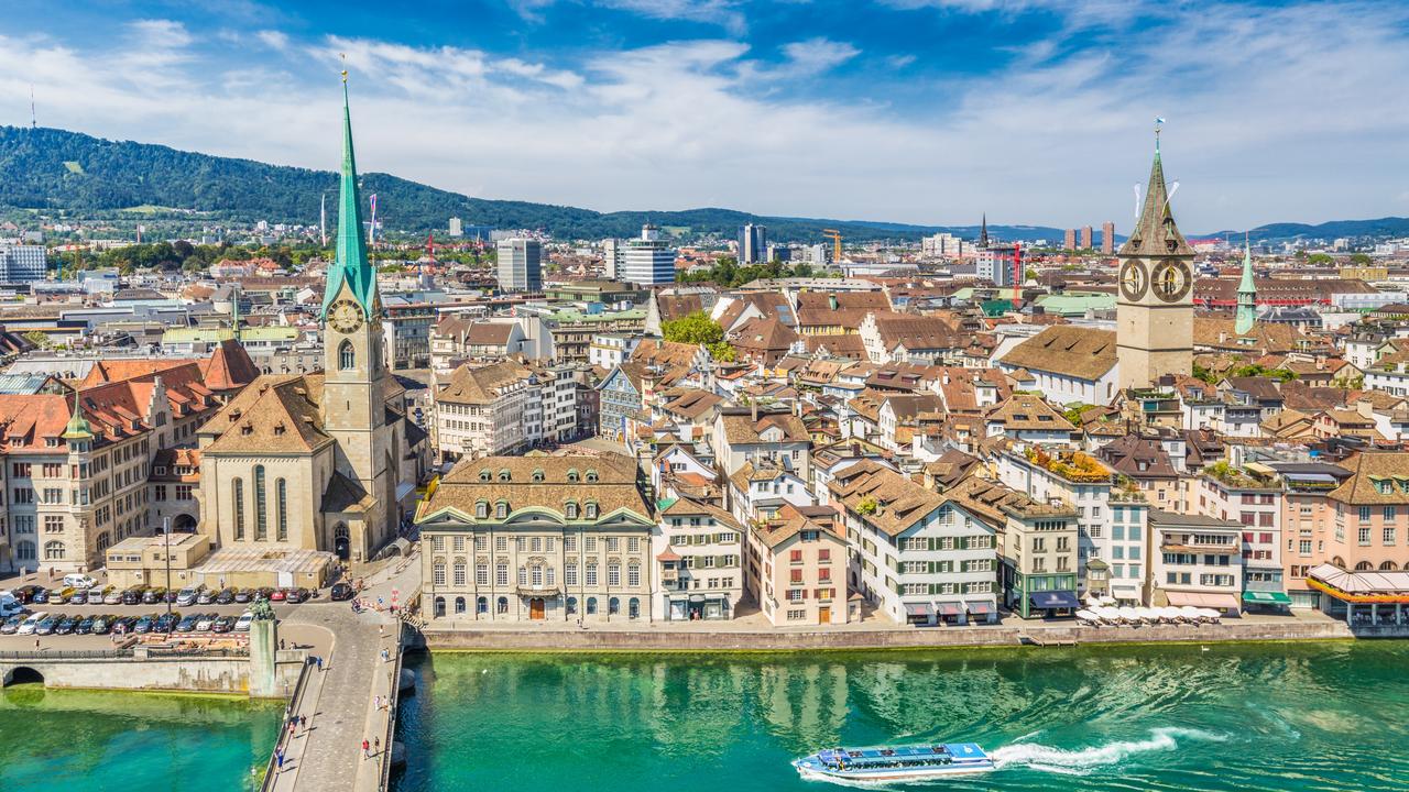 Aerial view of Zurich city centre with famous Fraumunster and Sankt Peter Churches and river Limmat at Lake Zurich seen from Grossmunster Church.