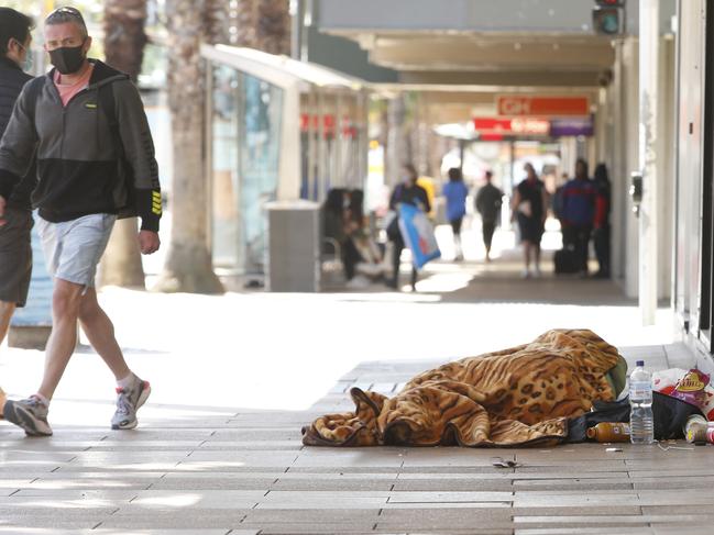 A person sleeping outside a vacant shop in Moorabool at midday Sunday. Signs of homelessness in Geelong CBD. Picture: Alan Barber