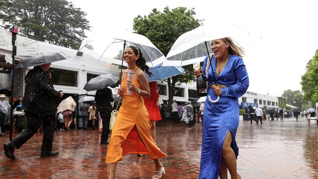 Spirits are high despite the deluge. Photo: Martin Keep