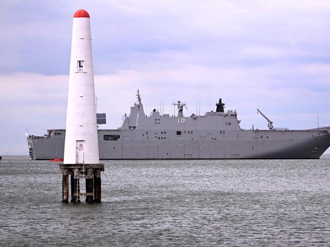 The HMAS Adelaide, a Royal Australian Navy (RAN) Canberra-class landing helicopter dock ship, docks at Station Pier in Melbourne on March 19, 2024. (Photo by William WEST / AFP)