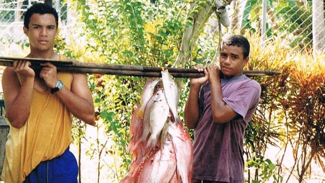 Will Genia (right) with his brother Frank and a catch of red emperor fish in PNG.