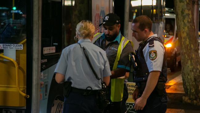 Witnesses said the bus driver (middle in vest) was abused before a chemical was sprayed in his face. Picture: Damian Hoffman